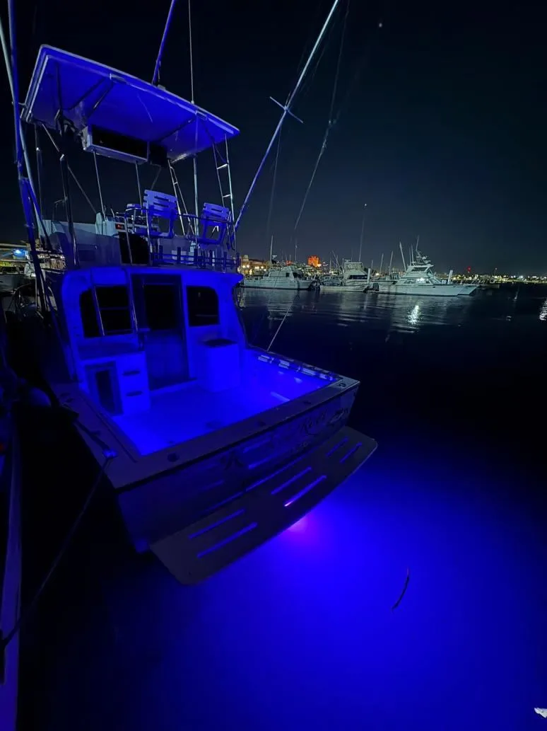 1989 Albemarle 325 convertible sportfisher for sale, at the dock at night with underwater lights